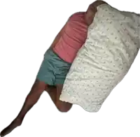 a man in a pink shirt is laying on his stomach with a white pillow