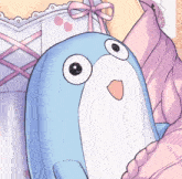 a blue stuffed animal with big eyes is being held by a girl