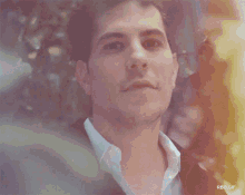a close up of a man 's face behind a tree with rbd.gif written on the bottom