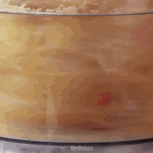 a food processor is filled with a yellow substance and says mr.bakes on the bottom