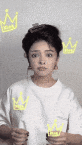 a woman wearing a white shirt with the word king on it
