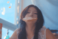 a woman eating a piece of bread with her mouth open
