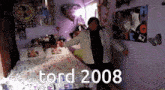 a person dancing in a bedroom with the year 2008 on the bottom right