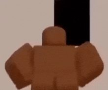 a brown robot is standing in front of a white wall holding a black box .