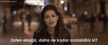 a woman is crying with the words " zaten eksikiz daha ne kadar azalabiliriz ki "