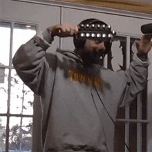 a man wearing headphones and a thrasher shirt
