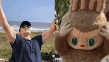 a man with his arms outstretched and a stuffed animal with green eyes