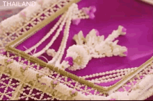 a close up of a piece of crocheted lace with the word thailand on the bottom