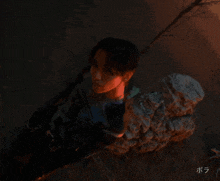 a person with chinese writing on the bottom right corner