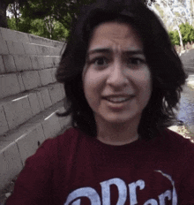 a woman wearing a red t-shirt that says dr. on it