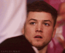 a close up of a man 's face making a surprised face .