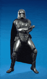 a storm trooper with a black cape is standing in front of a blue sky