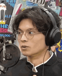 a man wearing headphones and glasses looks surprised