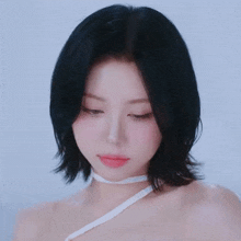 a close up of a woman 's face with a white ribbon around her neck