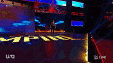 a man stands on a stage in front of a sign that says fire