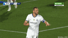 two soccer players are giving each other a high five during a match