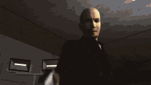 a bald man is holding a gun in his right hand