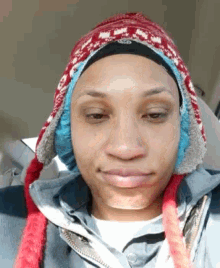 a woman wearing a hat and ear muffs is sitting in a car