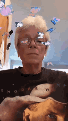 a woman wearing glasses and a t-shirt that says book on it