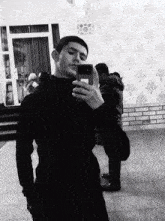 a man taking a selfie with a phone that has a sticker on it that says ' i love you '