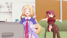 two anime girls are sitting on a couch and one is standing