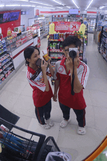 a boy and a girl are taking a picture in a store