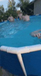 a group of people are swimming in a large pool