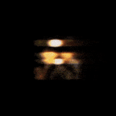 a painting of a sun with a black background and yellow rays