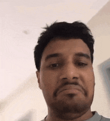 a man with a beard is making a funny face .