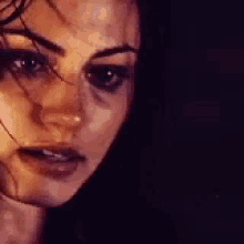 a close up of a woman 's face with a serious look on her face