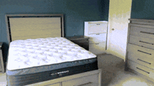 a bed with a helix midnight mattress on top of it