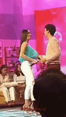 a man and a woman are dancing on a stage with #mayward written below them