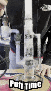 a person is smoking a bong with the words puff time written on it