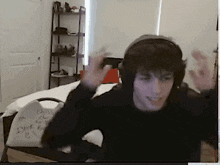 a man wearing headphones is dancing in a room