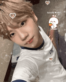 a young man taking a selfie with a kenshin nic sticker on his face