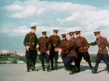 a group of soldiers in uniform are dancing together