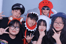 a group of young people posing for a picture with one girl wearing a shirt that says ' summer ' on it