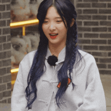a girl with long blue hair is wearing a white shirt