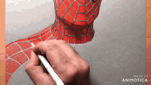 a person is drawing a spiderman with a pen