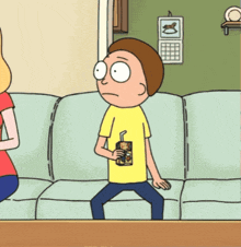 a cartoon of a man sitting on a couch drinking a drink through a straw