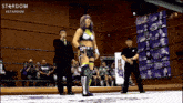 a woman in a wrestling ring with the words stardom on the bottom