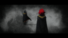 a person with red hair is standing next to another person in a black cape