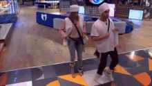 a man and a woman are dancing on a dance floor in a room