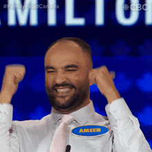 a man wearing a name tag that says ameen