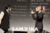 a man and a woman standing next to each other with the words sam y ina on the bottom right