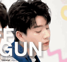a close up of a man 's face with gun written in white letters