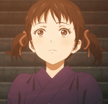 a close up of a girl 's face with pigtails