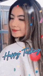 a woman with her eyes closed has the words happy tasking written on her back