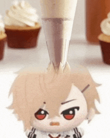 a stuffed animal is being decorated with frosting and cupcakes in the background .