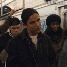 a man in a black jacket is standing in a crowd of people with the hashtag #karatekidmovie on the bottom